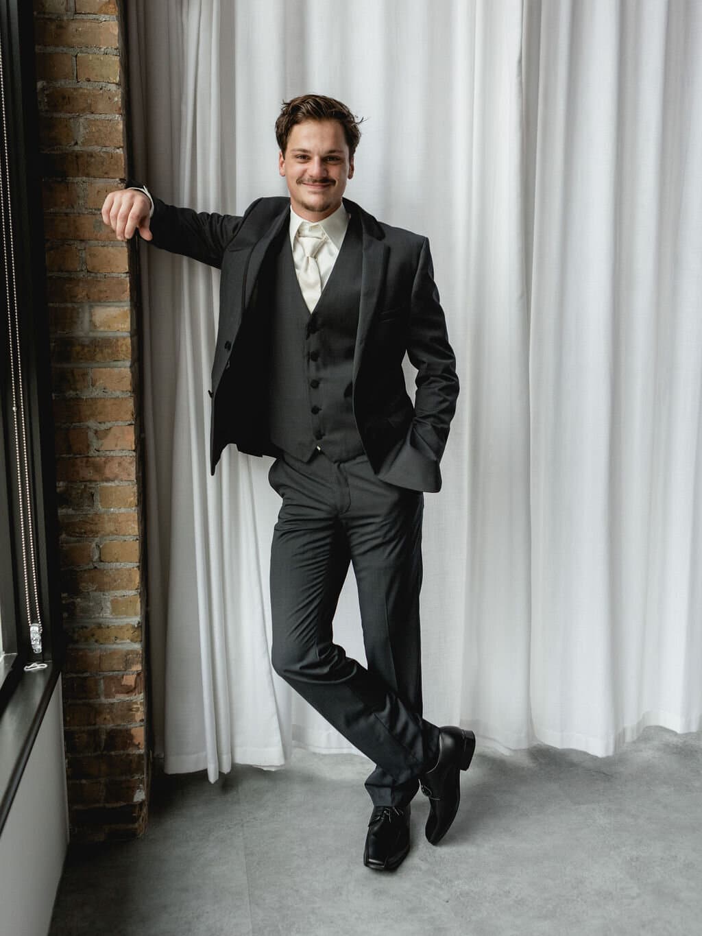 Groom in tailored wedding suit from Bridal Aisle Boutique — formal wear near Maple Grove MN